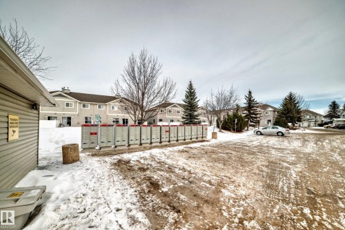 Snowy yard featuring mail area and a residential view - 185 230 Edwards Drive, Edmonton, AB - Outdoor