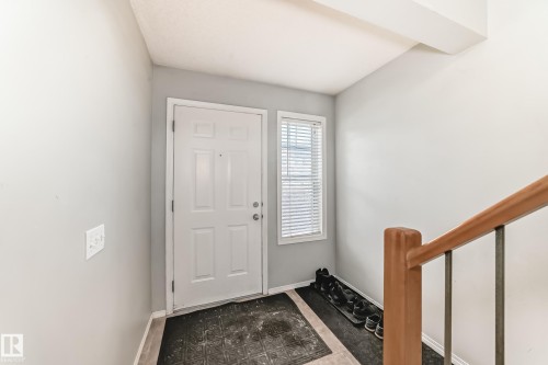 Foyer entrance with stairs and baseboards - 185 230 Edwards Drive, Edmonton, AB - Indoor Photo Showing Other Room