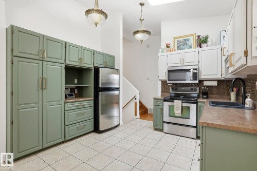 10703 31 Street, Edmonton, AB - Indoor Photo Showing Kitchen With Double Sink