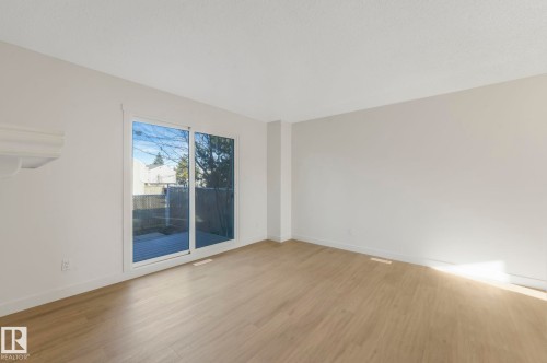 Unfurnished room with wood finished floors and baseboards - 5833 Riverbend Road, Edmonton, AB - Indoor Photo Showing Other Room