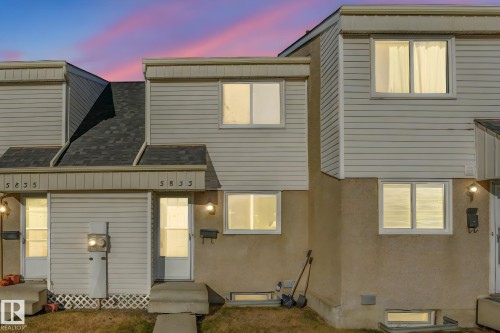 View of front of home featuring roof with shingles, entry steps, and stucco siding - 5833 Riverbend Road, Edmonton, AB - Outdoor