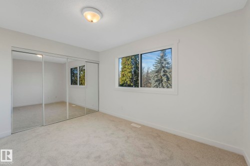 Unfurnished bedroom with a closet and carpet flooring - 5833 Riverbend Road, Edmonton, AB - Indoor Photo Showing Other Room