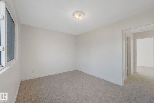 Unfurnished room with light carpet and baseboards - 5833 Riverbend Road, Edmonton, AB - Indoor Photo Showing Other Room