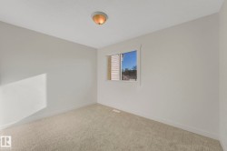 Carpeted spare room featuring baseboards - 