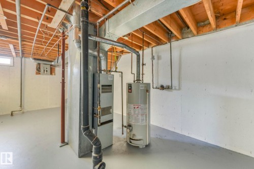 Basement with gas water heater - 5833 Riverbend Road, Edmonton, AB - Indoor Photo Showing Basement
