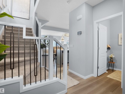 Stairs with baseboards and wood finished floors - 207 41 Avenue, Edmonton, AB - Indoor Photo Showing Other Room