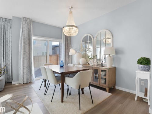 Dining area with wood finished floors and hanging lights - 207 41 Avenue, Edmonton, AB - Indoor Photo Showing Dining Room