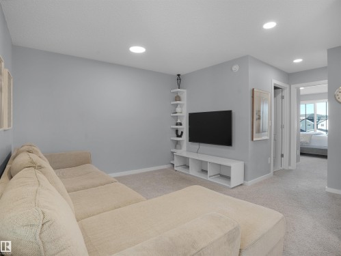 Living room featuring light carpet and recessed lighting - 207 41 Avenue, Edmonton, AB - Indoor