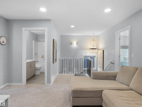 Living room with light colored carpet, recessed lighting, and a textured ceiling - 207 41 Avenue, Edmonton, AB - Indoor