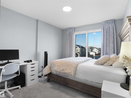 Carpeted bedroom featuring access to outside and a desk - 207 41 Avenue, Edmonton, AB - Indoor Photo Showing Bedroom