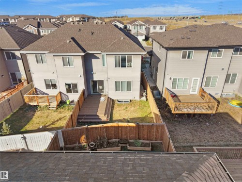 Rear view of property with a deck, a fenced backyard, a residential view, and roof with shingles - 207 41 Avenue, Edmonton, AB - Outdoor