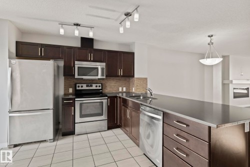 #62 4050 Savaryn Drive Sw, Edmonton, AB - Indoor Photo Showing Kitchen With Double Sink