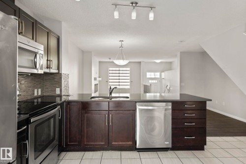 #62 4050 Savaryn Drive Sw, Edmonton, AB - Indoor Photo Showing Kitchen With Double Sink With Upgraded Kitchen
