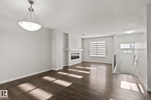 #62 4050 Savaryn Drive Sw, Edmonton, AB - Indoor With Fireplace