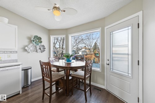Dining area with dark wood-style floors, a textured ceiling, and ceiling fan - 2952 39 Avenue, Edmonton, AB - Indoor Photo Showing Dining Room