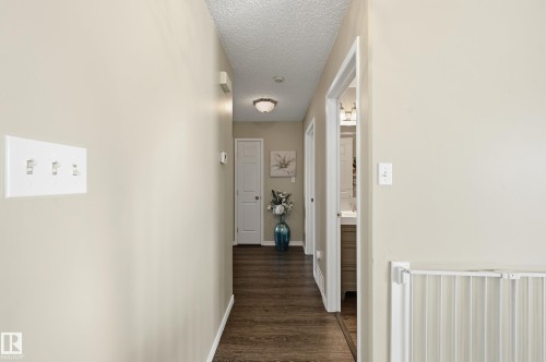 Hall with dark wood-type flooring and a textured ceiling - 2952 39 Avenue, Edmonton, AB - Indoor Photo Showing Other Room