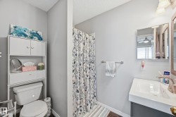 Full bath with a shower with shower curtain, vanity, a textured ceiling, and ceiling fan - 