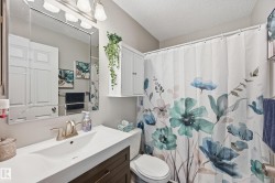 Full bath with a shower with curtain, vanity, and a textured ceiling - 