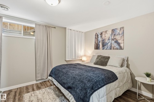 Bedroom with wood finished floors and baseboards - 2952 39 Avenue, Edmonton, AB - Indoor Photo Showing Bedroom