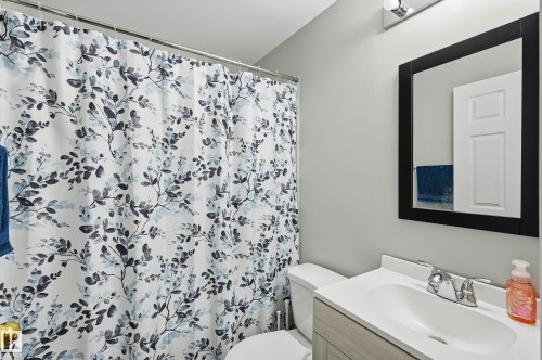 Bathroom featuring vanity and a shower with shower curtain - 2952 39 Avenue, Edmonton, AB - Indoor Photo Showing Bathroom