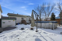 Yard layered in snow featuring a wooden deck - 