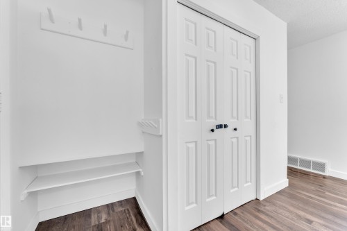 Detailed view of wood finished floors and a textured ceiling - 20920 9 Avenue, Edmonton, AB - Indoor Photo Showing Other Room