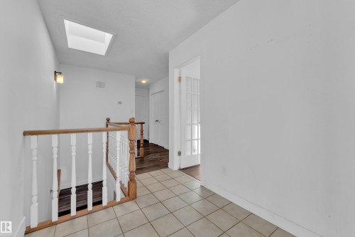 Hallway with a skylight, an upstairs landing, and light tile patterned floors - 20920 9 Avenue, Edmonton, AB - Indoor Photo Showing Other Room