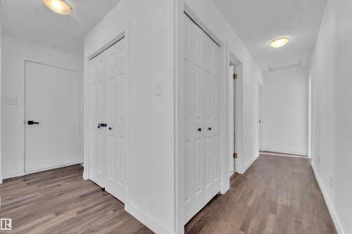 Hall featuring wood finished floors and a textured ceiling - 20920 9 Avenue, Edmonton, AB - Indoor Photo Showing Other Room