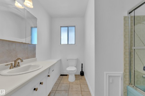 Bathroom with vanity and light tile patterned floors - 20920 9 Avenue, Edmonton, AB - Indoor Photo Showing Bathroom
