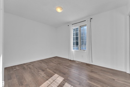 Spare room featuring wood finished floors - 20920 9 Avenue, Edmonton, AB - Indoor Photo Showing Other Room