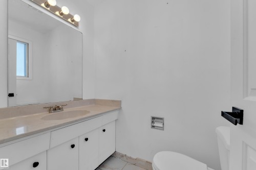 Half bath with vanity and toilet - 20920 9 Avenue, Edmonton, AB - Indoor Photo Showing Bathroom