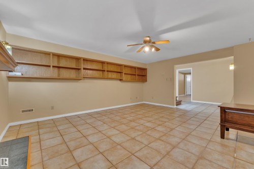 Empty room with a ceiling fan and light tile patterned floors - 20920 9 Avenue, Edmonton, AB - Indoor Photo Showing Other Room