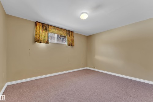 Carpeted spare room featuring baseboards - 20920 9 Avenue, Edmonton, AB - Indoor Photo Showing Other Room