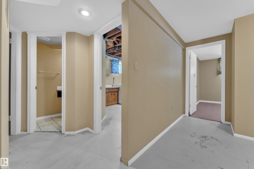 Hallway with baseboards and concrete floors - 20920 9 Avenue, Edmonton, AB - Indoor Photo Showing Other Room