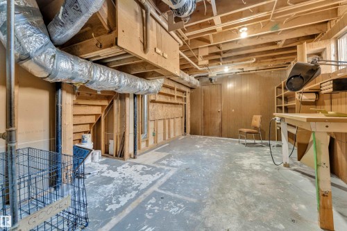 Unfinished basement with wood walls - 20920 9 Avenue, Edmonton, AB - Indoor Photo Showing Basement