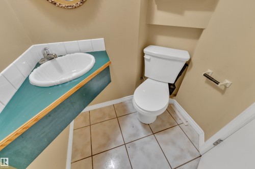 Half bath with tile patterned floors and vanity - 20920 9 Avenue, Edmonton, AB - Indoor Photo Showing Bathroom