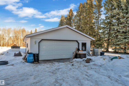 Snow covered garage featuring a detached garage - 20920 9 Avenue, Edmonton, AB - Outdoor
