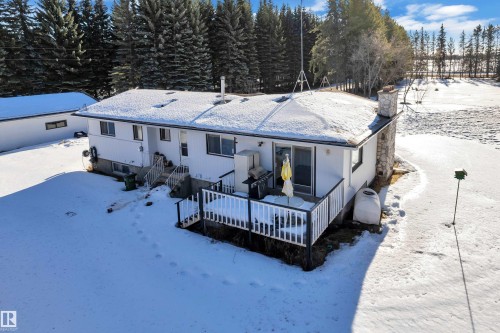 Snow covered rear of property with a chimney and a wooden deck - 20920 9 Avenue, Edmonton, AB - Outdoor