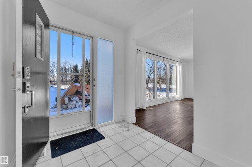 Foyer featuring light tile patterned floors and a textured ceiling - 20920 9 Avenue, Edmonton, AB - Indoor Photo Showing Other Room
