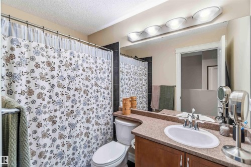 Bathroom featuring vanity, a shower with curtain, and a textured ceiling - 11715 167A Avenue, Edmonton, AB - Indoor Photo Showing Bathroom