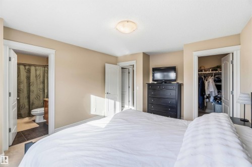 Bedroom featuring a walk in closet and connected bathroom - 11715 167A Avenue, Edmonton, AB - Indoor Photo Showing Bedroom
