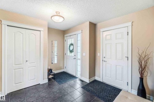 Foyer featuring a textured ceiling and dark tile patterned floors - 11715 167A Avenue, Edmonton, AB - Indoor Photo Showing Other Room