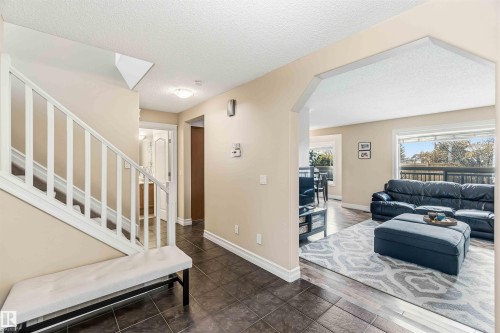 Foyer with a textured ceiling, arched walkways, and dark wood-style floors - 11715 167A Avenue, Edmonton, AB - Indoor