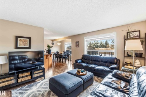 Living area with wood-type flooring and a textured ceiling - 11715 167A Avenue, Edmonton, AB - Indoor Photo Showing Living Room
