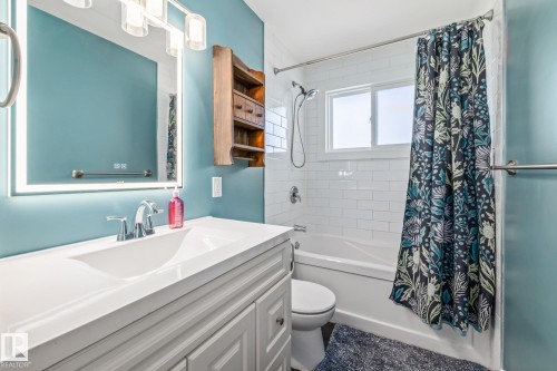 Bathroom with shower / bath combo and vanity - 14911 96 Street, Edmonton, AB - Indoor Photo Showing Bathroom