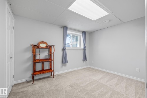 Carpeted empty room with a paneled ceiling and baseboards - 14911 96 Street, Edmonton, AB - Indoor Photo Showing Other Room