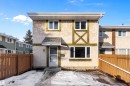 Back of house featuring stucco siding, a fenced backyard, roof with shingles, and entry steps - 15C Callingwood Crest, Edmonton, AB  - Outdoor 