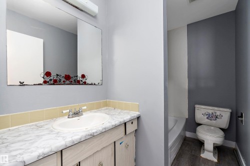 Full bath featuring vanity, a bathtub, and dark wood-style flooring - 15C Callingwood Crest, Edmonton, AB - Indoor Photo Showing Bathroom