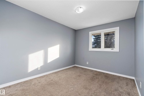 Carpeted spare room featuring baseboards - 15C Callingwood Crest, Edmonton, AB - Indoor Photo Showing Other Room