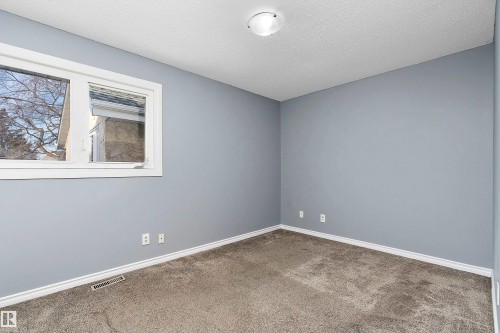Empty room featuring carpet floors and a textured ceiling - 15C Callingwood Crest, Edmonton, AB - Indoor Photo Showing Other Room